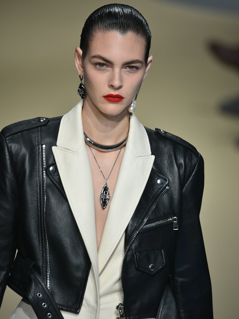 Vittoria Ceretti on the Alexander McQueen Fall/Winter 2018 runway in a leather biker jacket with red lipstick